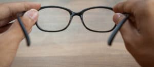 looking through glasses wood background