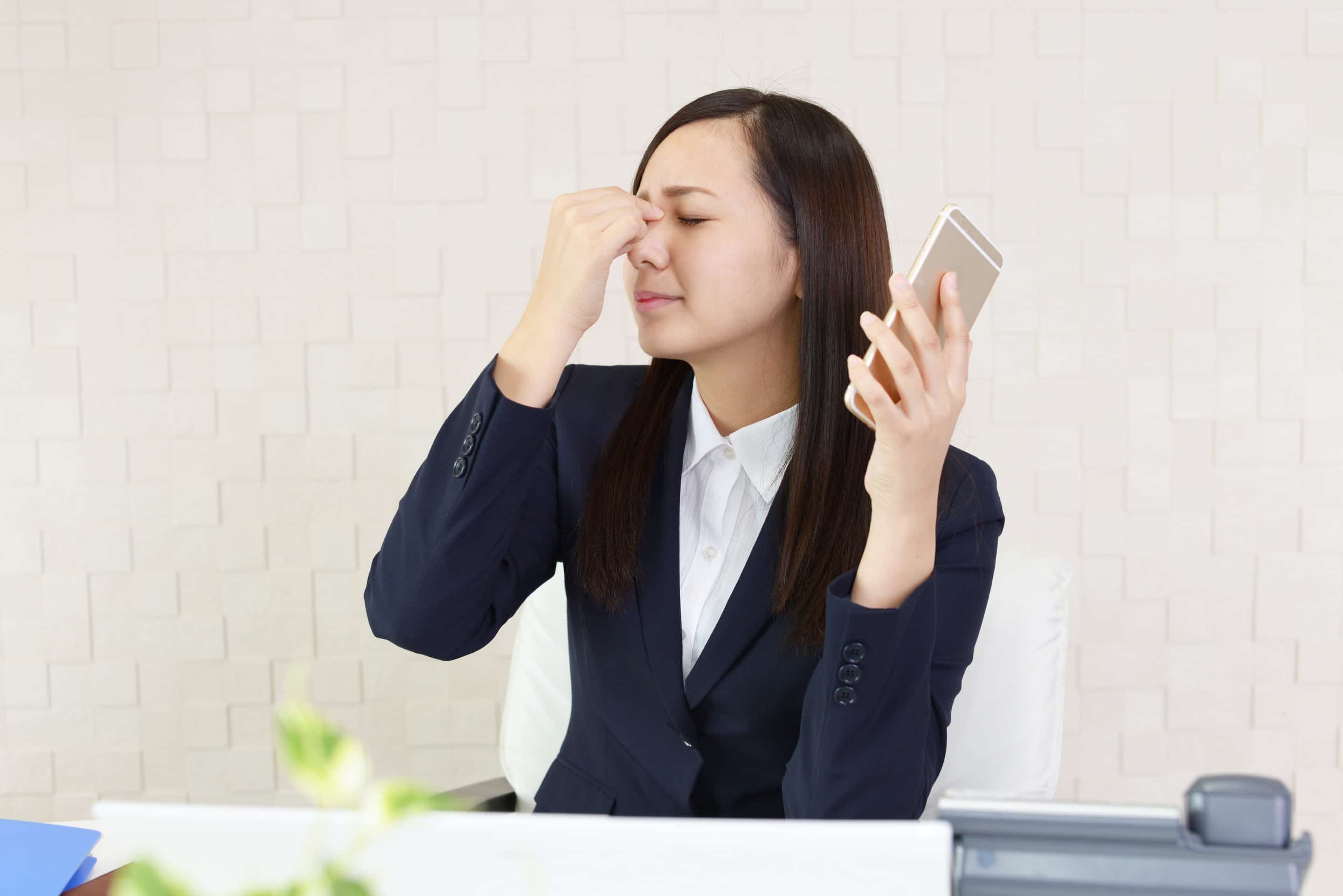 Woman's eyes hurting after looking at smartphone Sight Eye Clinic